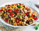 Un piatto colorato di insalata di grano saraceno con verdure miste arrosto: peperoni, zucchine, melanzane e pomodorini.