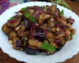 Melanzane in agrodolce, un piatto saporito con cipolle rosse, pinoli e menta fresca. Un'esplosione di gusto!