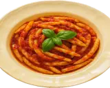 Piatto di pasta con nduja e basilico fresco, un classico sapore calabrese.