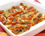 Parmigiana di patate al forno con pomodorini e erbe aromatiche, un piatto semplice e gustoso.