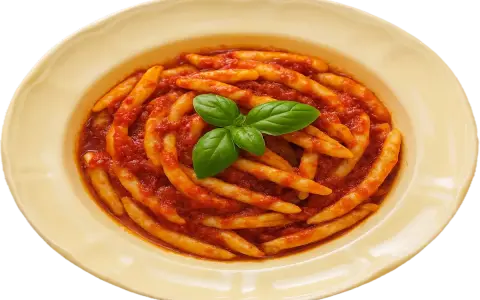 Piatto di pasta con nduja e basilico fresco, un classico sapore calabrese.