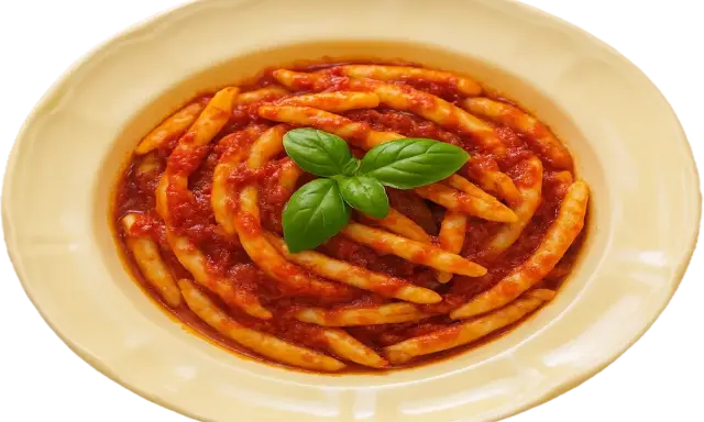 Piatto di pasta con nduja e basilico fresco, un classico sapore calabrese.